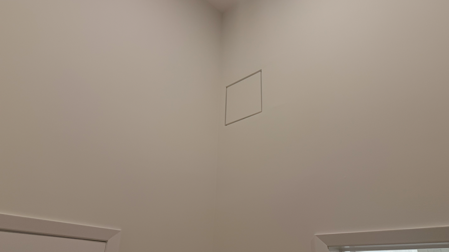Seam flush wall vent installed flush in a white-on-white wall — sitting perfectly flat against the drywall with no protruding frame, visually disappearing into the wall surface