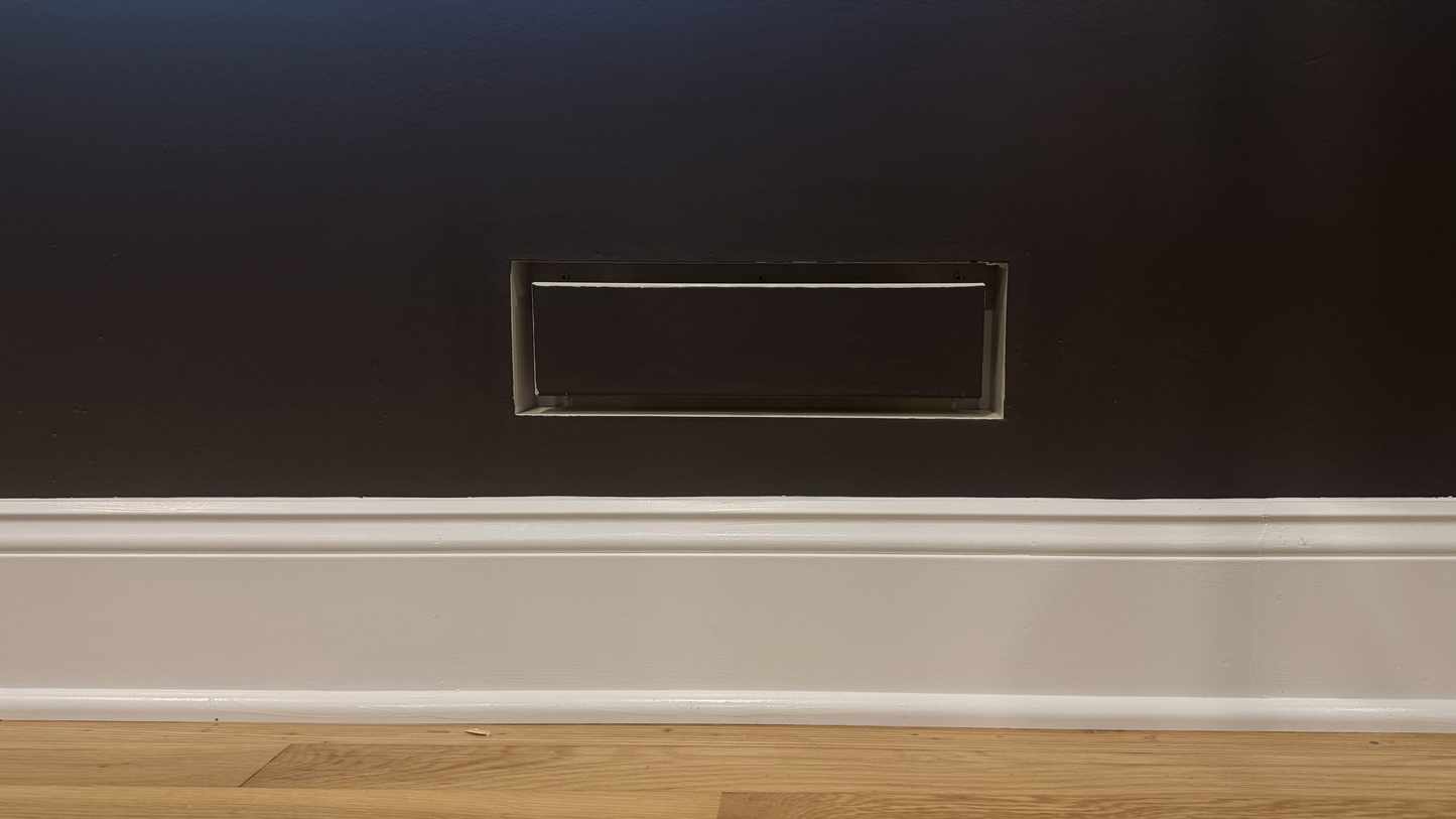 Seam flush wall vent installed and painted to match a warm mauve wall and baseboard — demonstrating the paintable matte powder-coat finish integrating with a muted, warm color palette