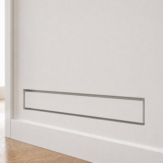 Seam 4×14 flush wall vent installed as a slim horizontal slot in a white wall — the long, low profile reads as architectural detail rather than HVAC hardware